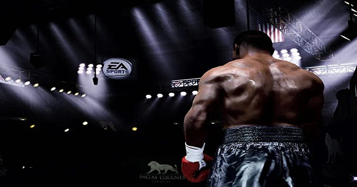 02-fight-night Boxeador de espaldas bajo los focos de una arena de boxeo con el logotipo de EA Sports